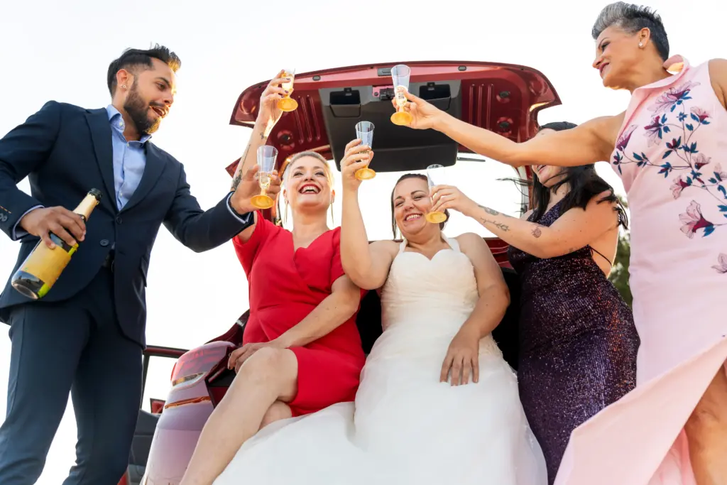 Bride and friends toasting with champagne after wedding ceremony