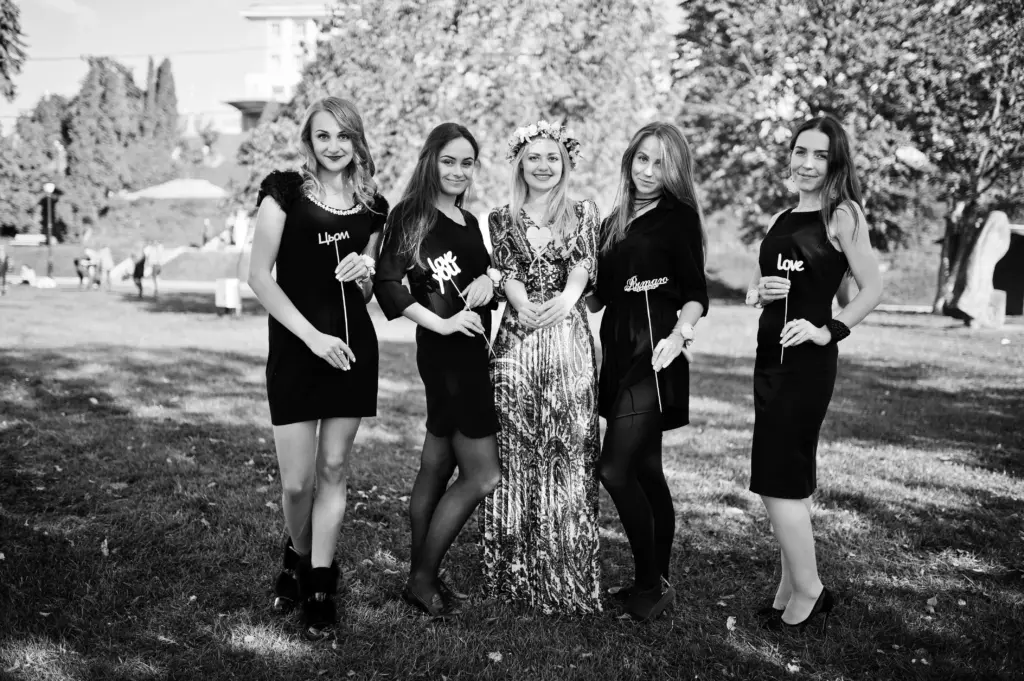 Five girls wear black having fun hen party