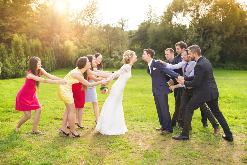 Bridesmaids and Groomsmen Pulling the Newlyweds Together
