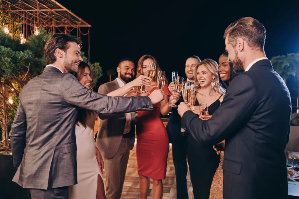 Group of happy people in formalwear toasting with champagne