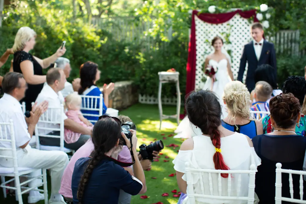Photographer is a woman photographing a wedding ceremony 