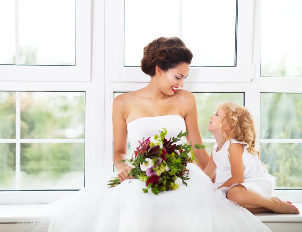 Smiling happy bride and a flower indoors